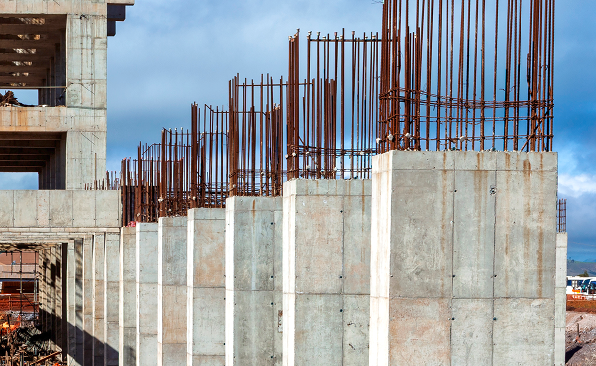 Concrete building under construction with steel rods